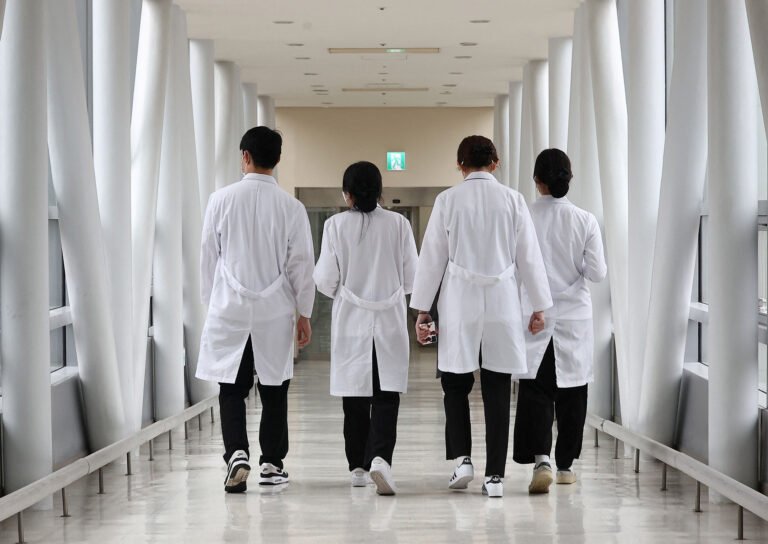 Medical workers walk at a hospital in Seoul
